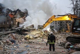 Rescuers work at the site of an apartment building hit by a Russian missile strike, amid Russia's attack on Ukraine, in Kharkiv, Ukraine